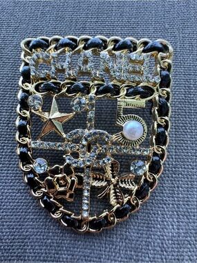 Luxury Gold-Tone Shield Brooch with Black Enamel & Clear Rhinestones